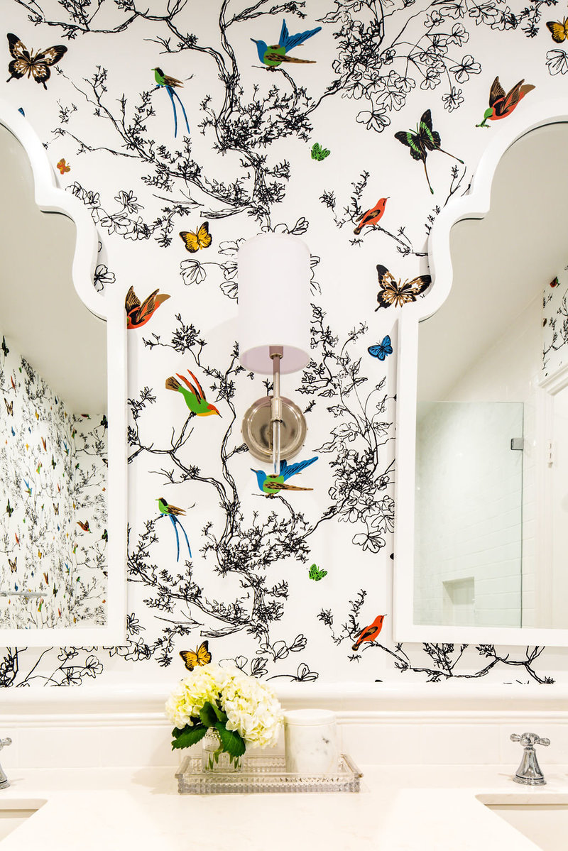 Bathroom with white arch mirrors and Schumacher Birds and Butterflies wallpaper