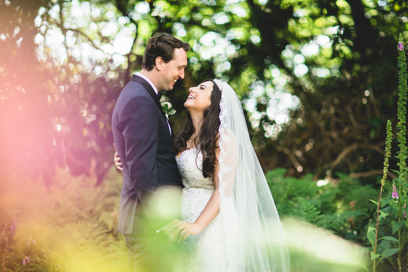 bright wedding photo of a jewish wedding couple in the gardens at nunsmere hall
