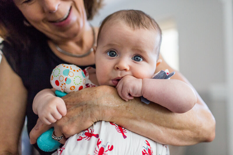 Grandma holding baby during documentary family photography session in Denver, Colorado