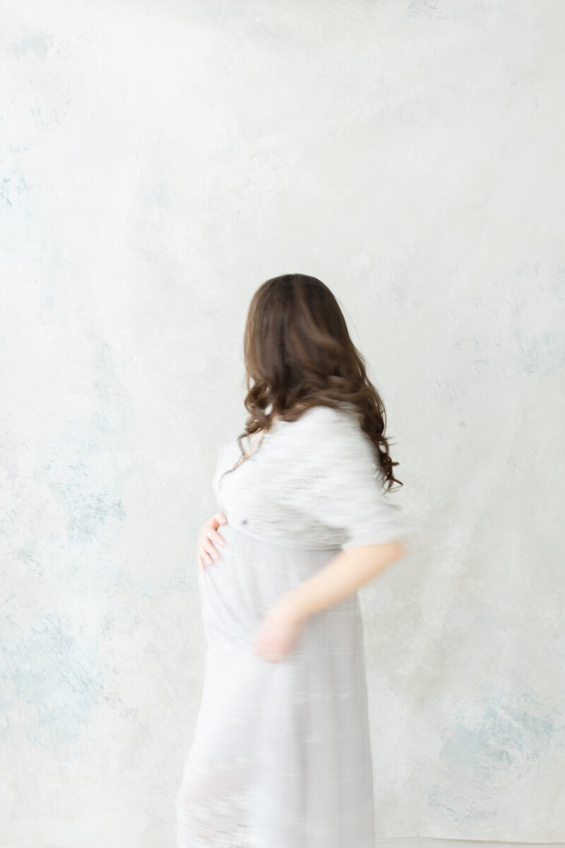 Stunning pregnant woman poses for maternity portrait