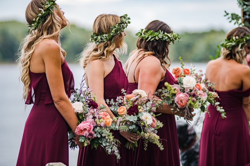 Wedding party bouquet with rich jewel tones in burgundy, coral and deep pink featuring Alaskan peonies, garden roses and local foliage