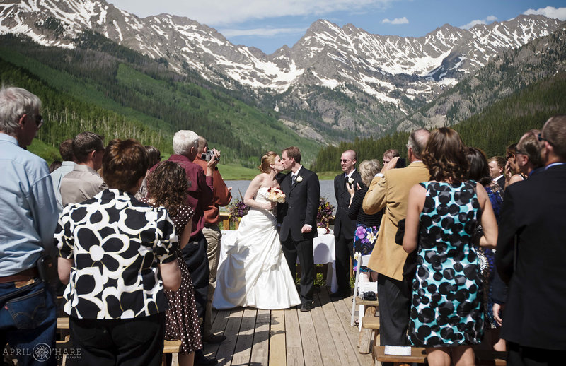 Kissing on the deck at outdoor Vail Wedding Ceremony