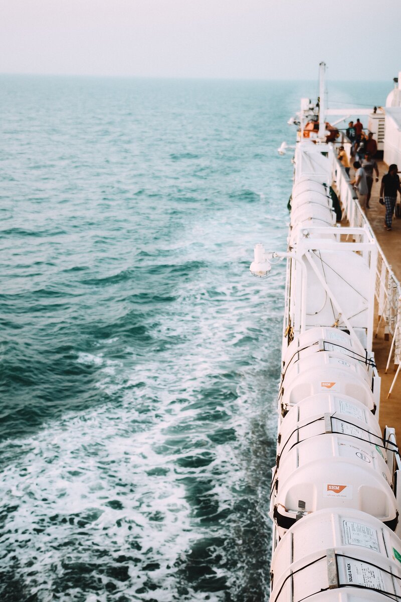 people on the deck of a cruise ship at sea