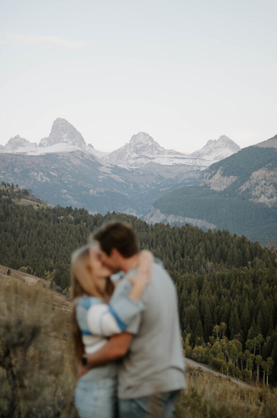 Couple kissing in front of the Grand Tetons