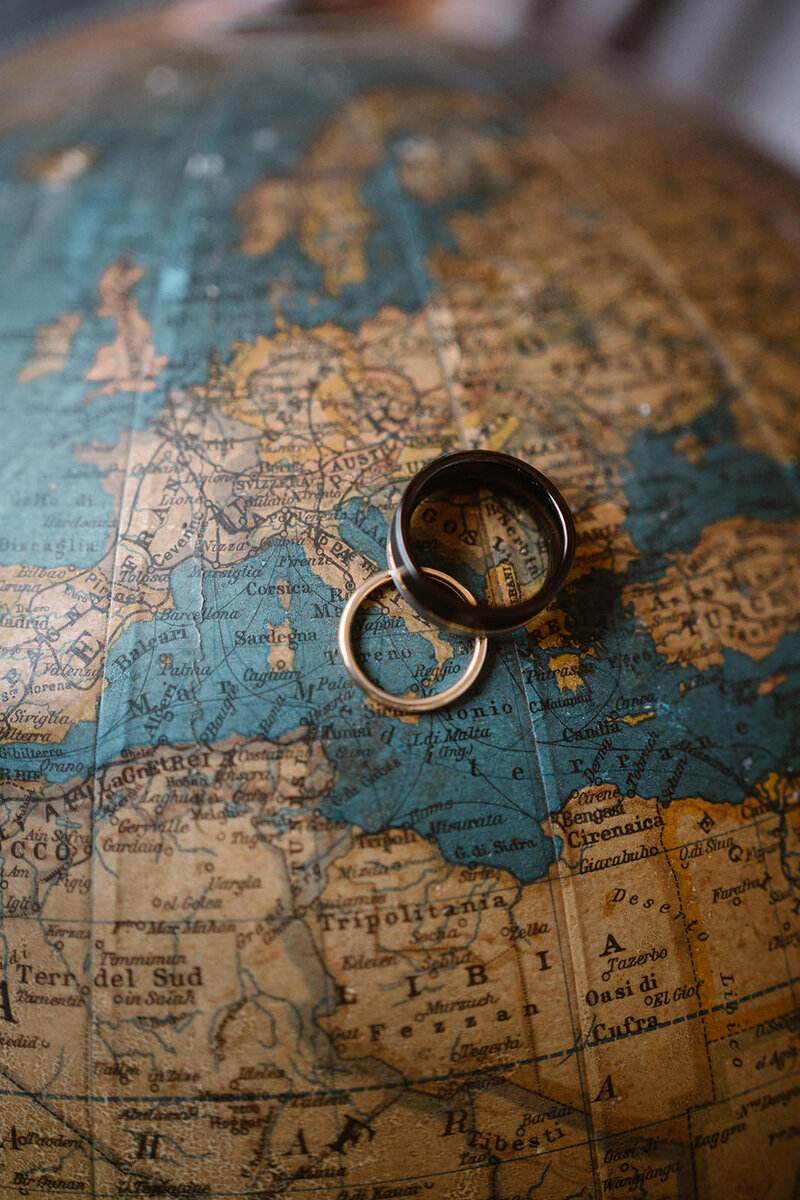 Wedding rings detail on a world map,