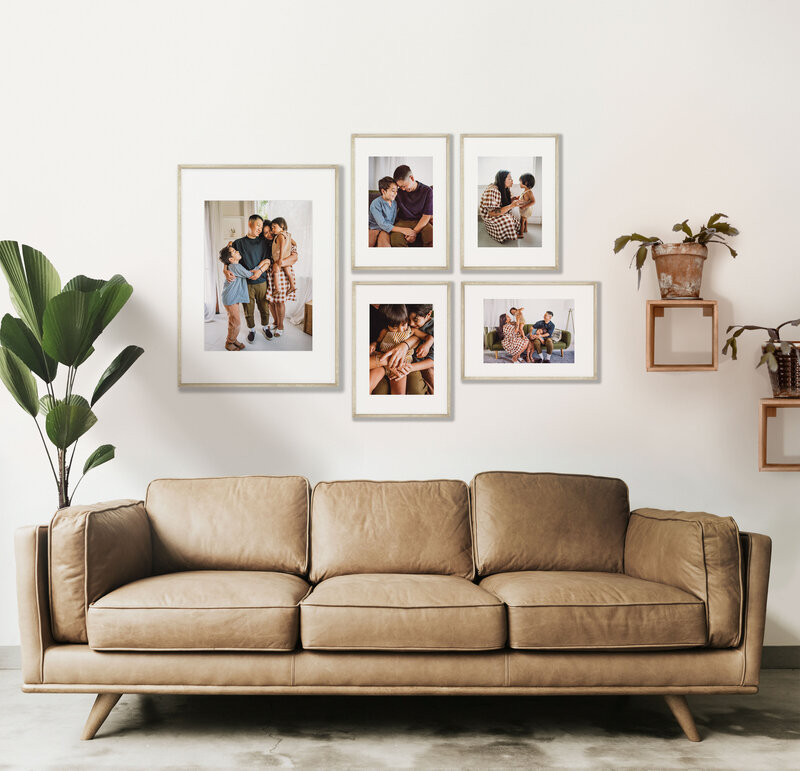 gallery wall of familiy photos above leather couch