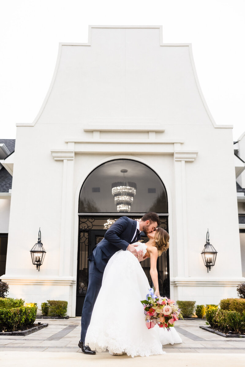 Bride and groom embrace at the Olana wedding venue in Hickory Creek, Texas.