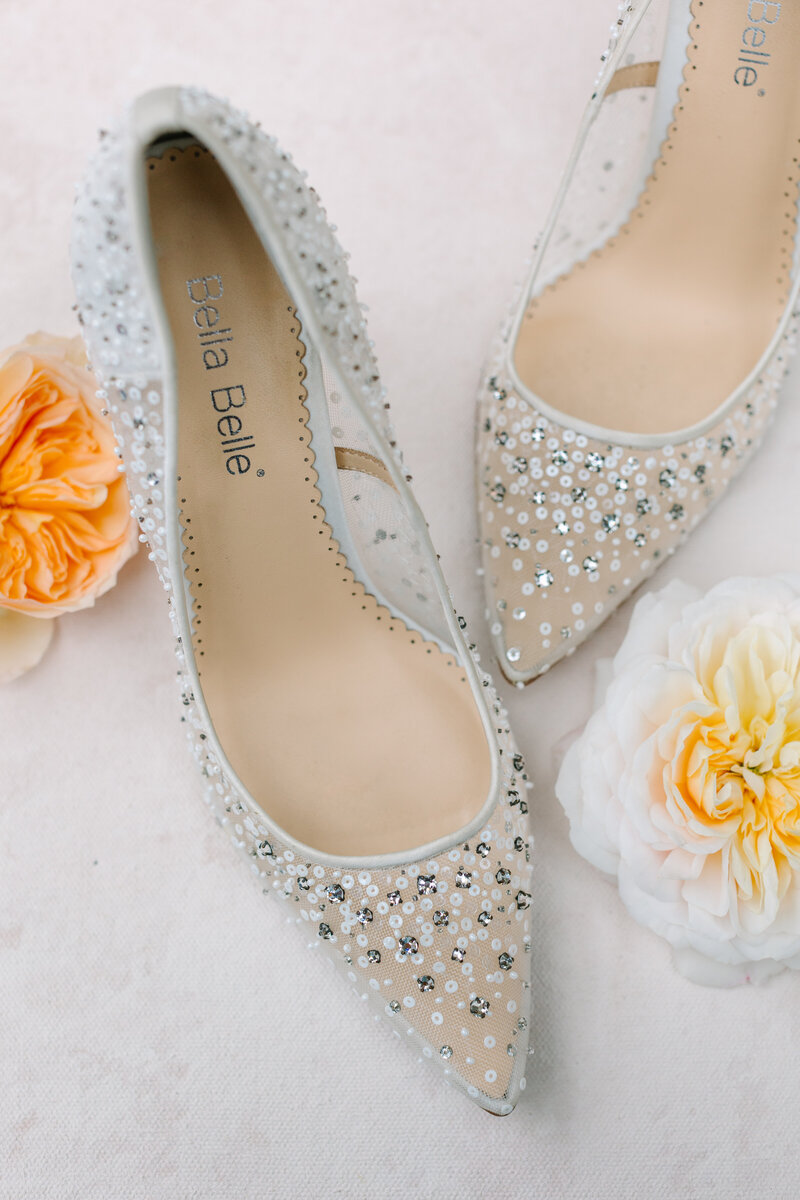 white bridal heels with beaded design and flowers.