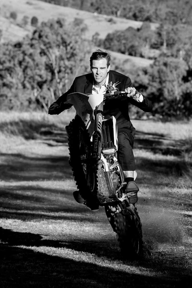 Cool groom riding his motorbike on the wedding day