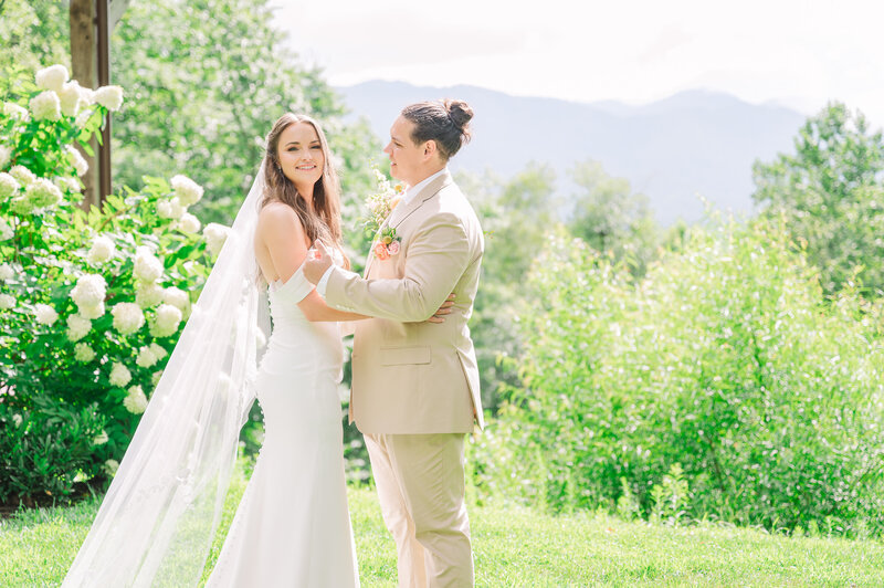 A laughing bride and groom exiting their wedding ceremony in the Virginia mountains by JoLynn Photography