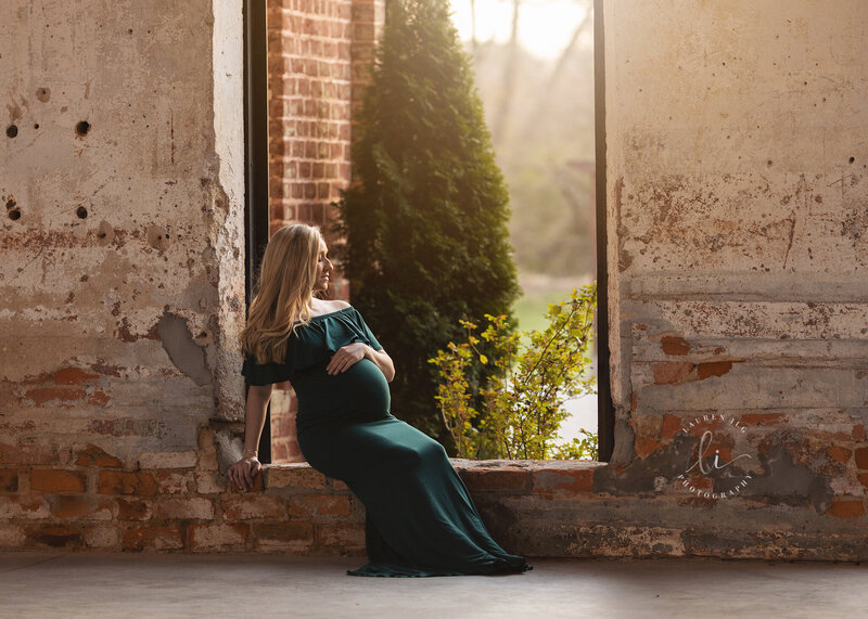 Maternity session at The Providence Cotton Mill in Maiden, NC with mom sitting in open window