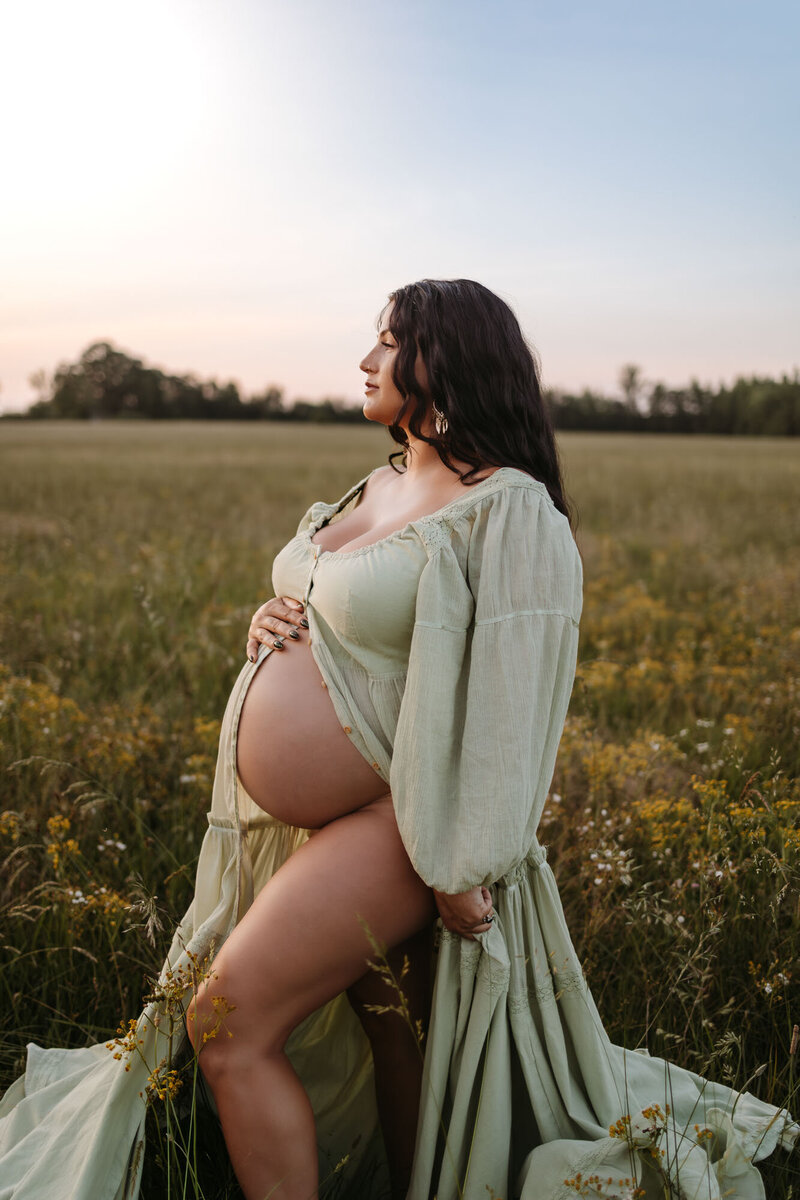 maternity photo of pregnant woman in light green dress