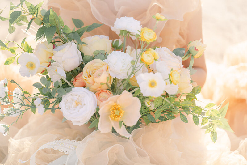 Peach bouquet with poppies, ranunculus, and other delicate florals