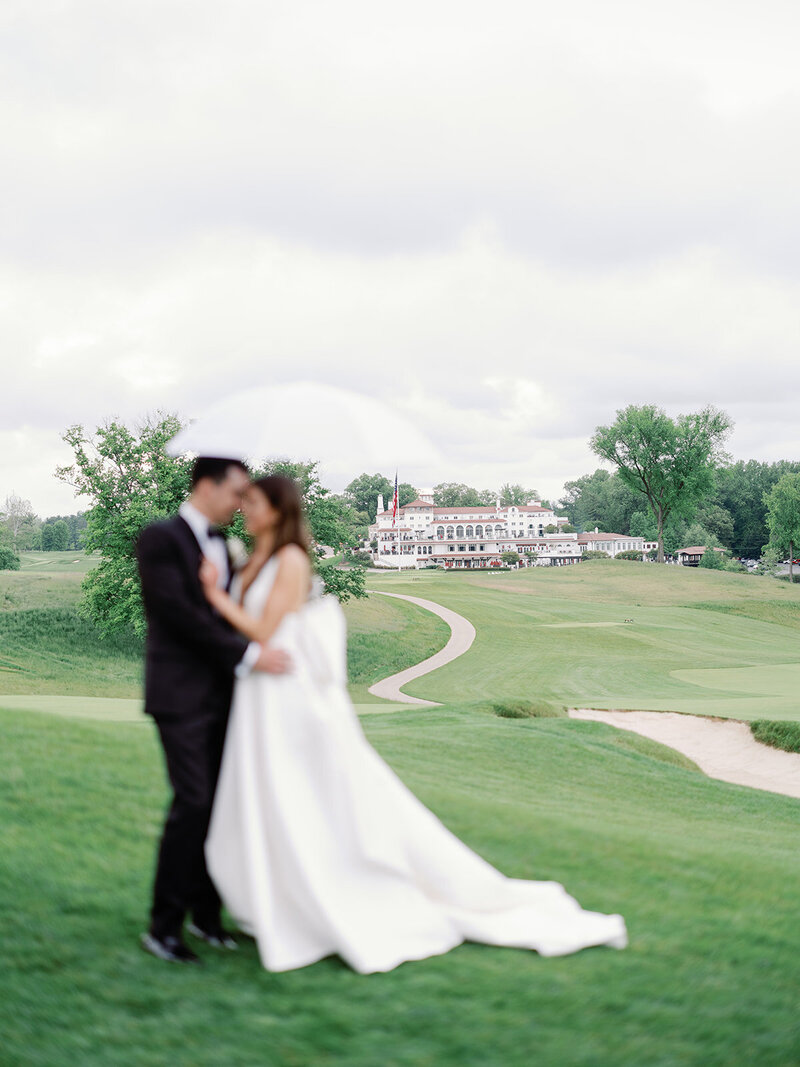 A bride and groom blurred in the backgound you see congrassional country club located in Bethesda MD.