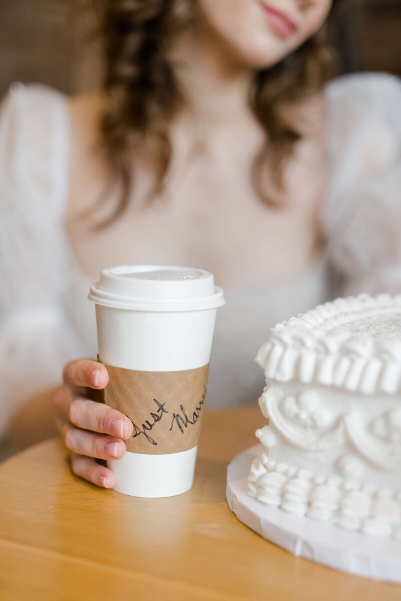 bride holding coffee on wedding day