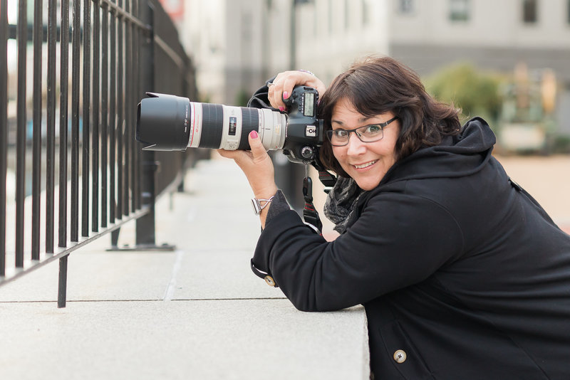 Photographer Claire Spampinato smiles from behind her camera