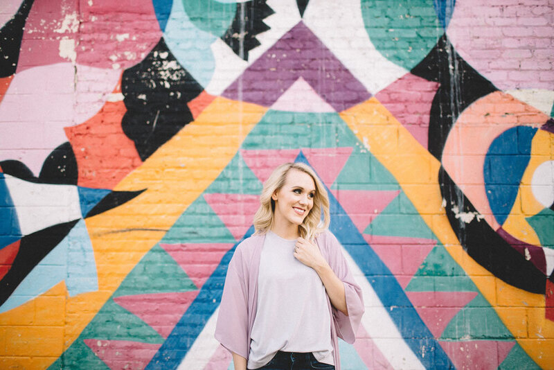 happy girl in front of colorful graffiti environmental portrait