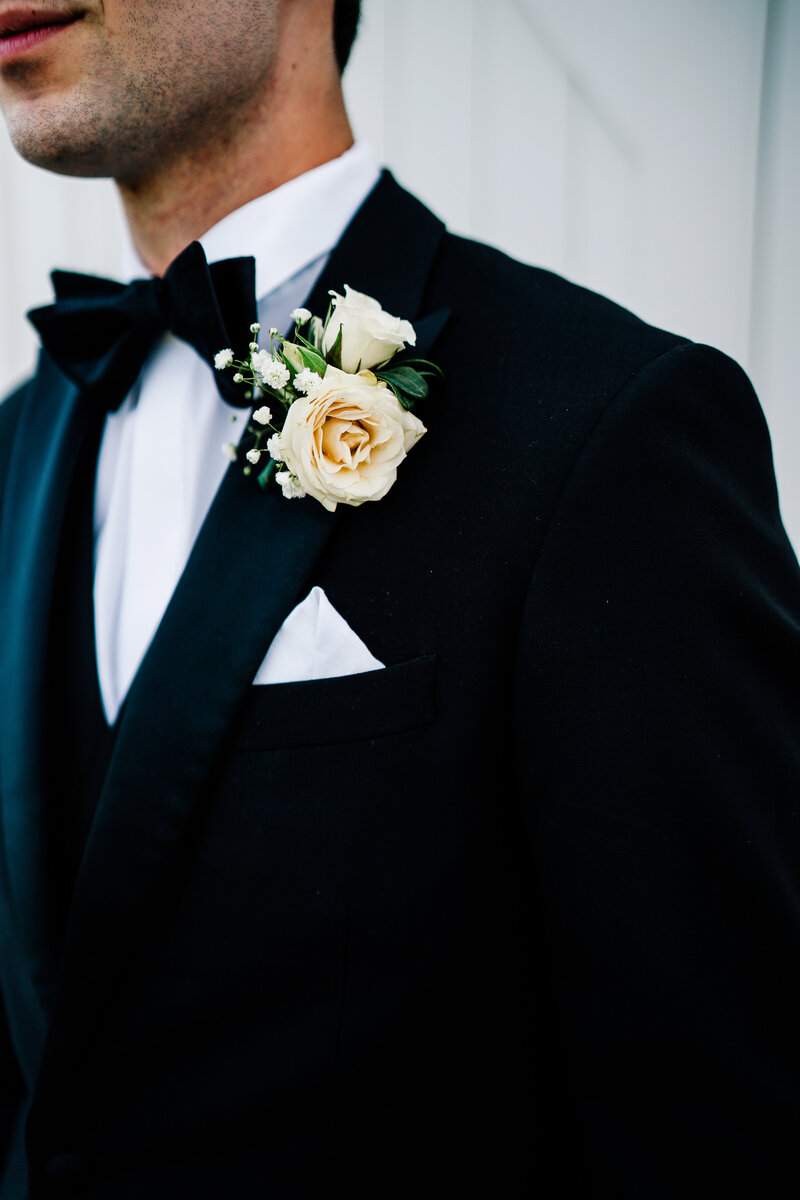 A groom detail shot of a grooms jacket