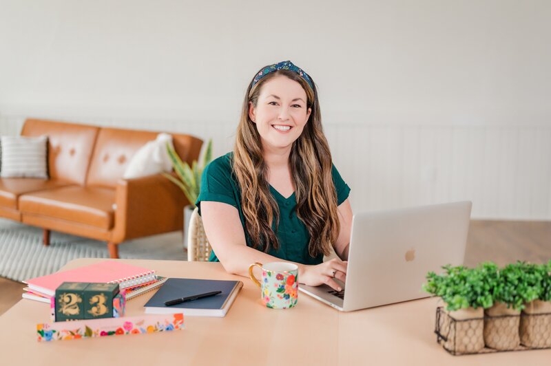 Kelli smiling while working at her desk