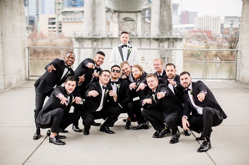 groomsmen squatting in front of groom by Knoxville Wedding Photographer, Amanda May Photos