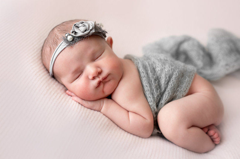 Newborn baby girl posed in bum up position during bay head studio newborn session.