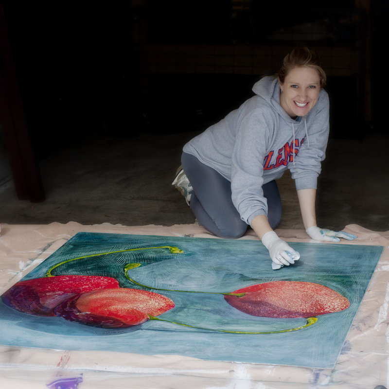 Portrait of Erin Tetterton painting a large scale painting of cherries