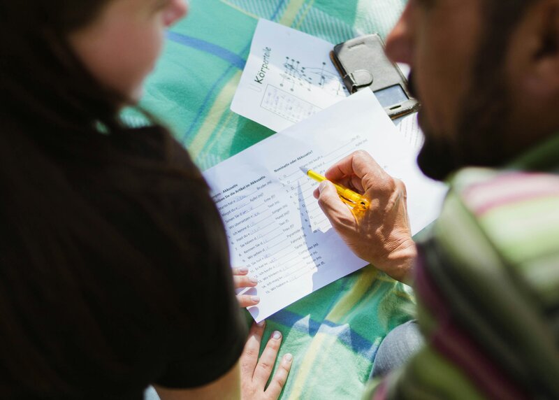 A student and teacher working on a test together