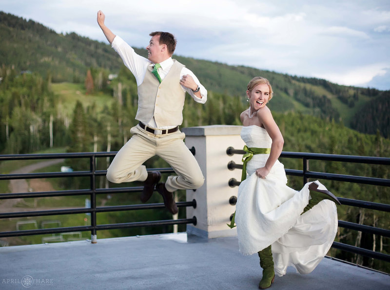Cute couple show their excitement on the deck outside of Champagne Powder Room on the day of their wedding in Steamboat Springs Colorado
