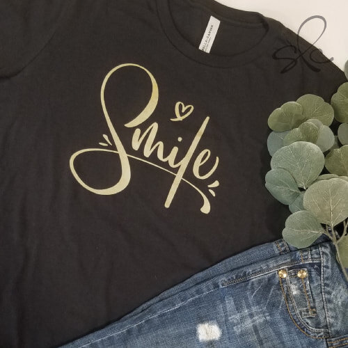 Black t-shirt with custom hand lettered text "Smile" and a heart illustration
