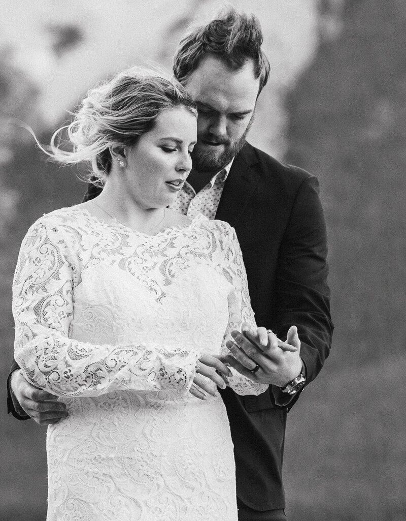 Bride-and-groom-holding-hands-in-wedding-photo