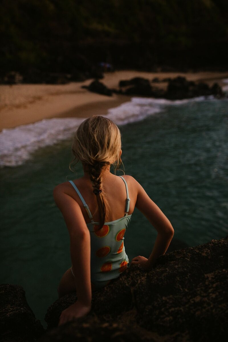 A girl looks out into the ocean.