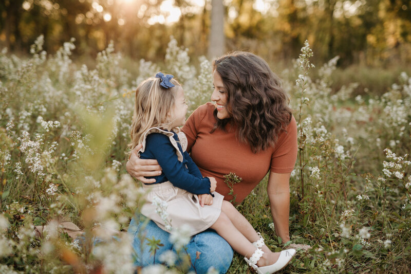 mom holding daughter during lifestyle session