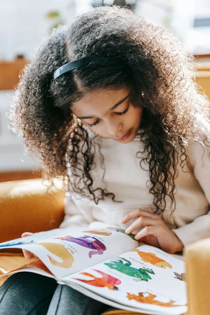 Young female student reading a picture book