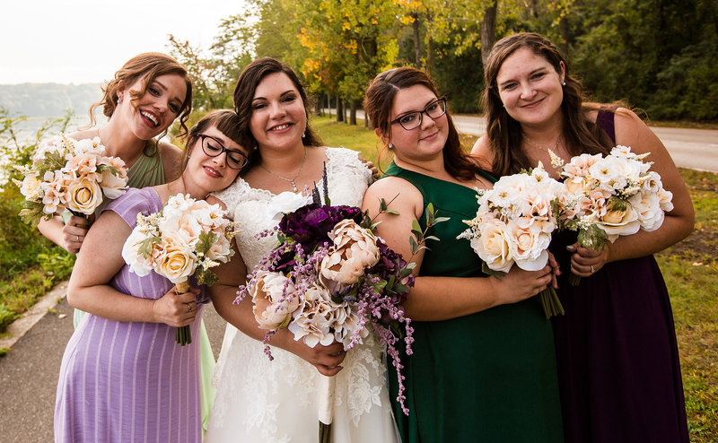 Bride smiles with her bridesmaids  at Presque Isle State Park