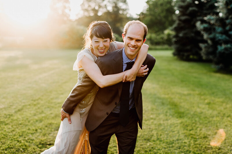 bride and groom laughing with sunset light