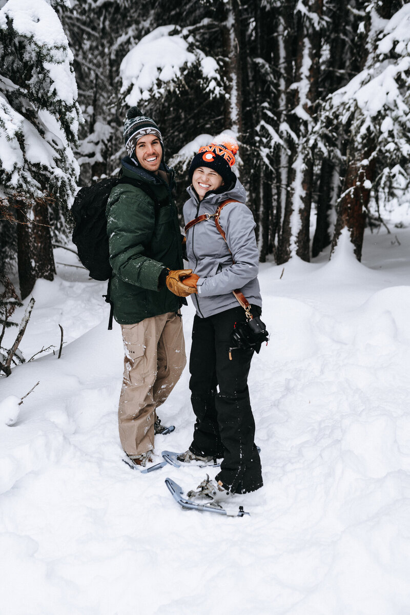 Couple snowshoeing in Colorado for engagement photos