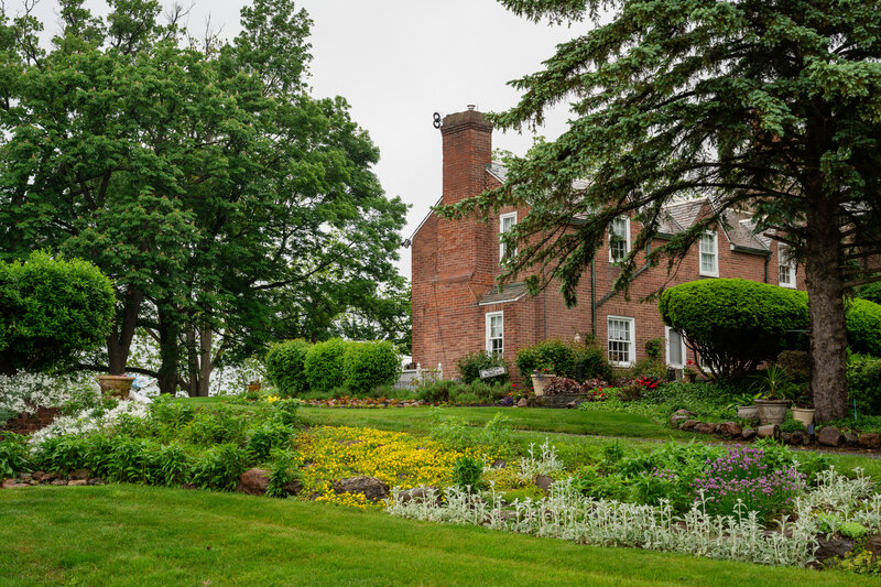 Charming ivy-covered stone house surrounded by lush gardens – photographed by wedding photographer Niko Coric – Lumen Clarity Media
