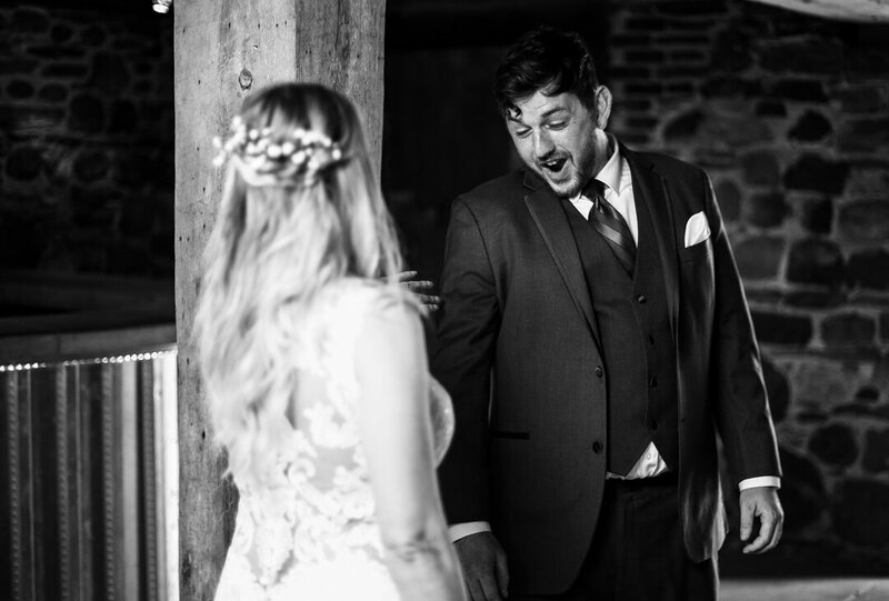 Groom reacts to seeing his bride during first look photos at Quincy Cellars