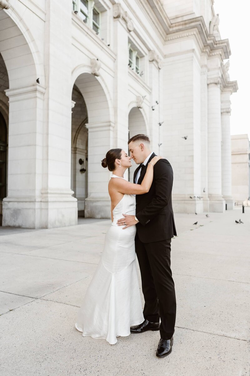 Wedding couple pose in front of Union Station during their Washington DC Elopement.