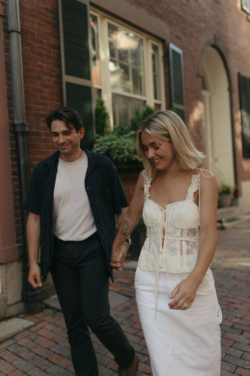 a couple walking down the streets of Boston for their documentary engagement photos