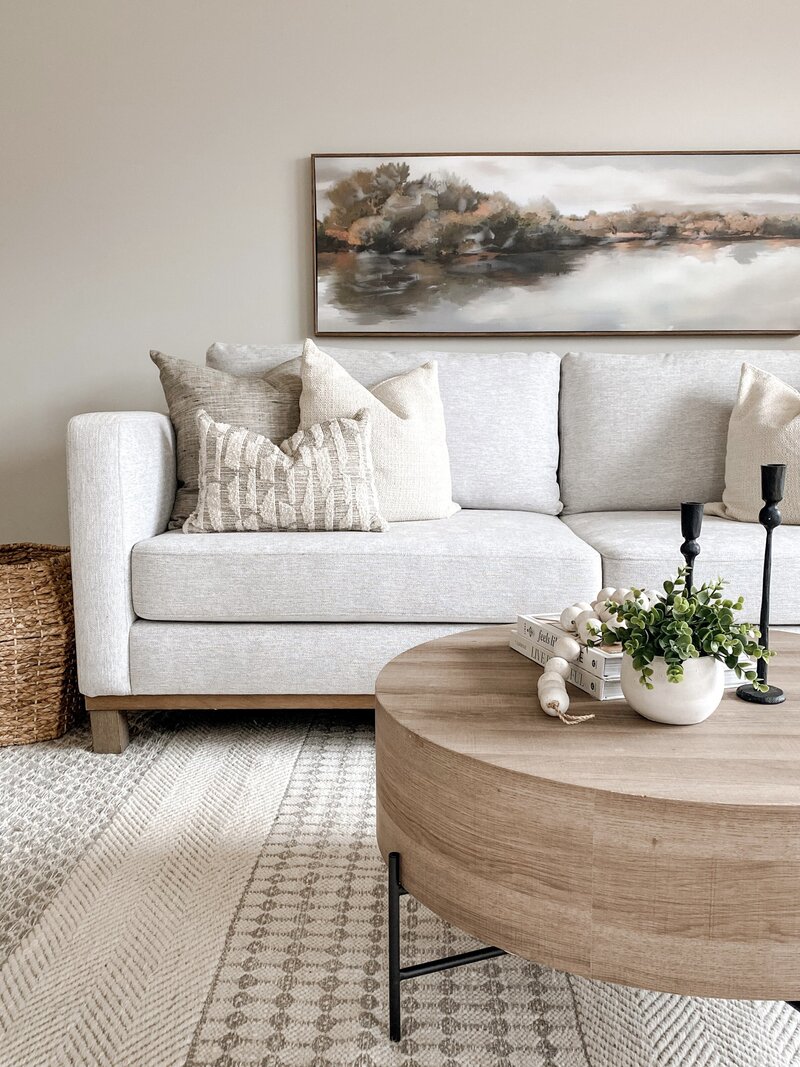 Subtle and neutral colour palette, layering in neutral textures and natural elements to a living room of a semi detached house located in East Royalty Charlottetown PEI