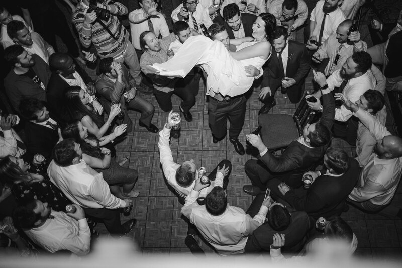 a wedding couple dances in the midst of all their people on their wedding day
