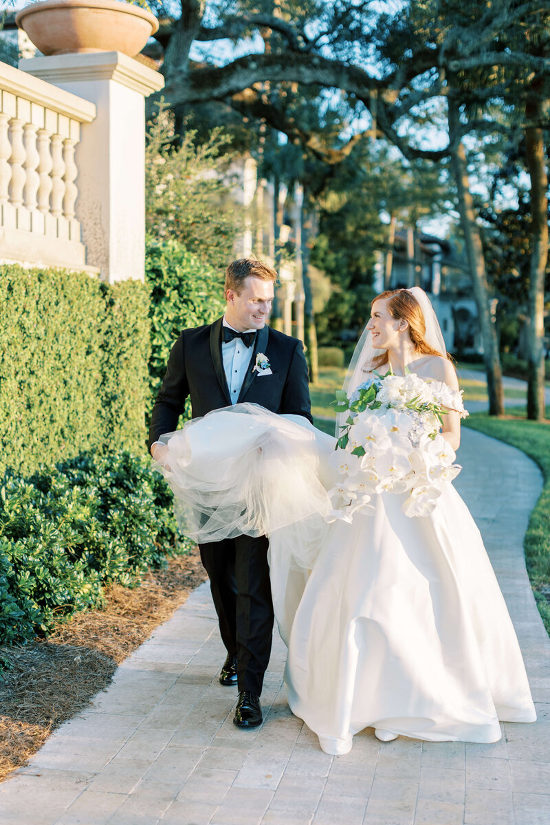 A bride smiles over her shoulder outside Westin Savannah