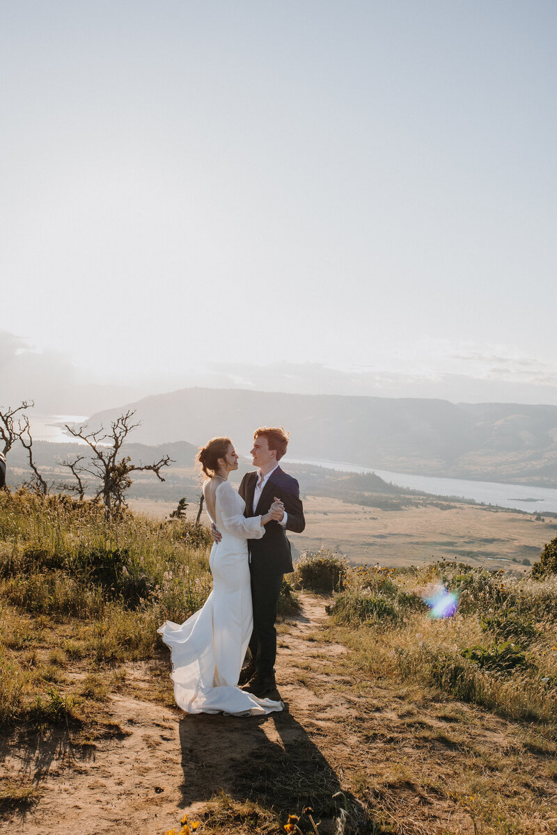 Bride and groom dancing on a mountain top