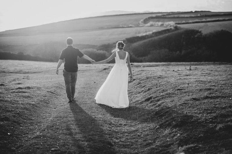 Couple take a walk on their wedding day in Cornwall