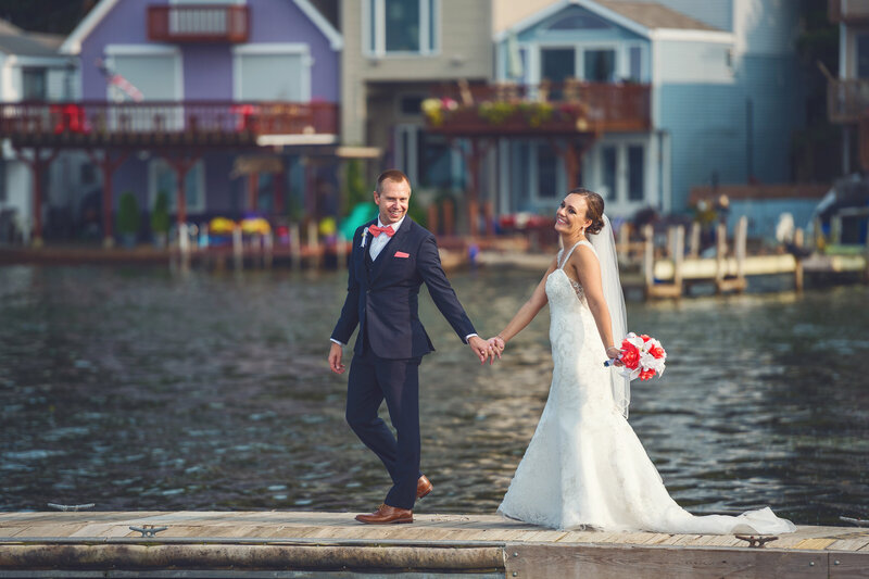 Wedding couple walking on pier at the Erie Yacht Club.