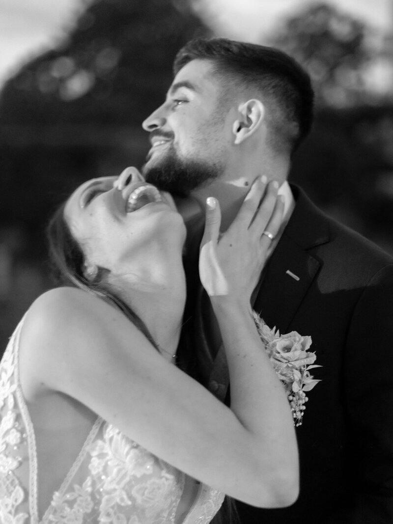 A-black-and-white-photo-of-a-bride-and-groom-hugging