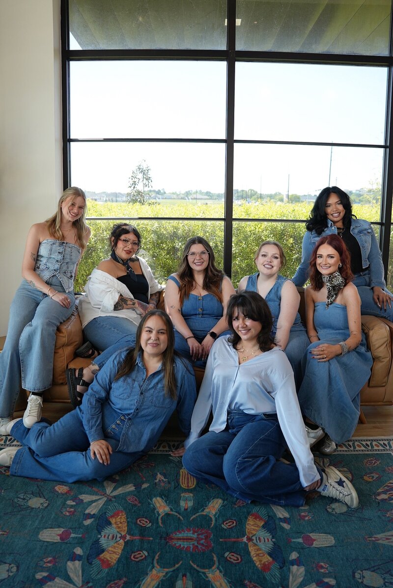 The SoCo leadership team smiling together in the salon, showcasing their fun and welcoming energy.