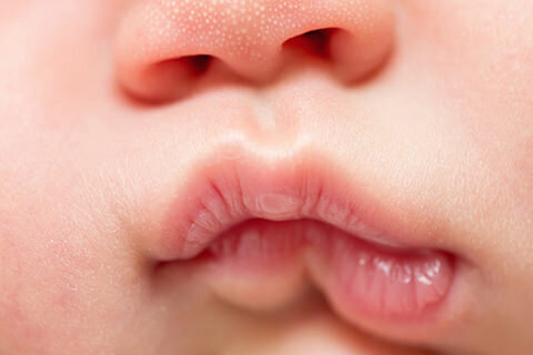 Close up photo of a newborn baby's lips.