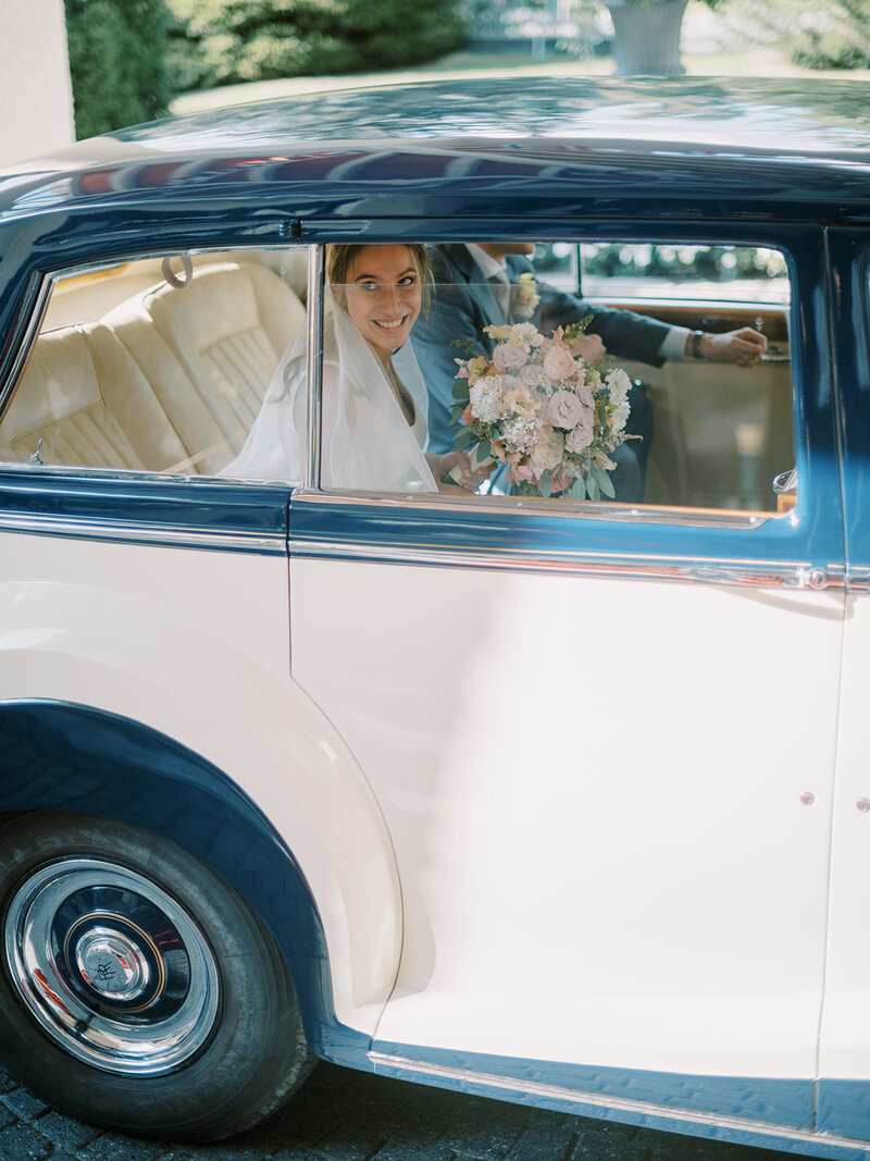 A-bride-and-groom-in-a-vintage-car